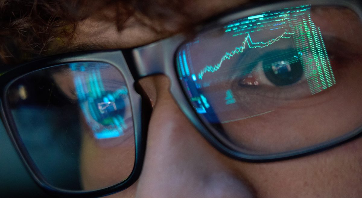 Stock chart reflecting in glasses